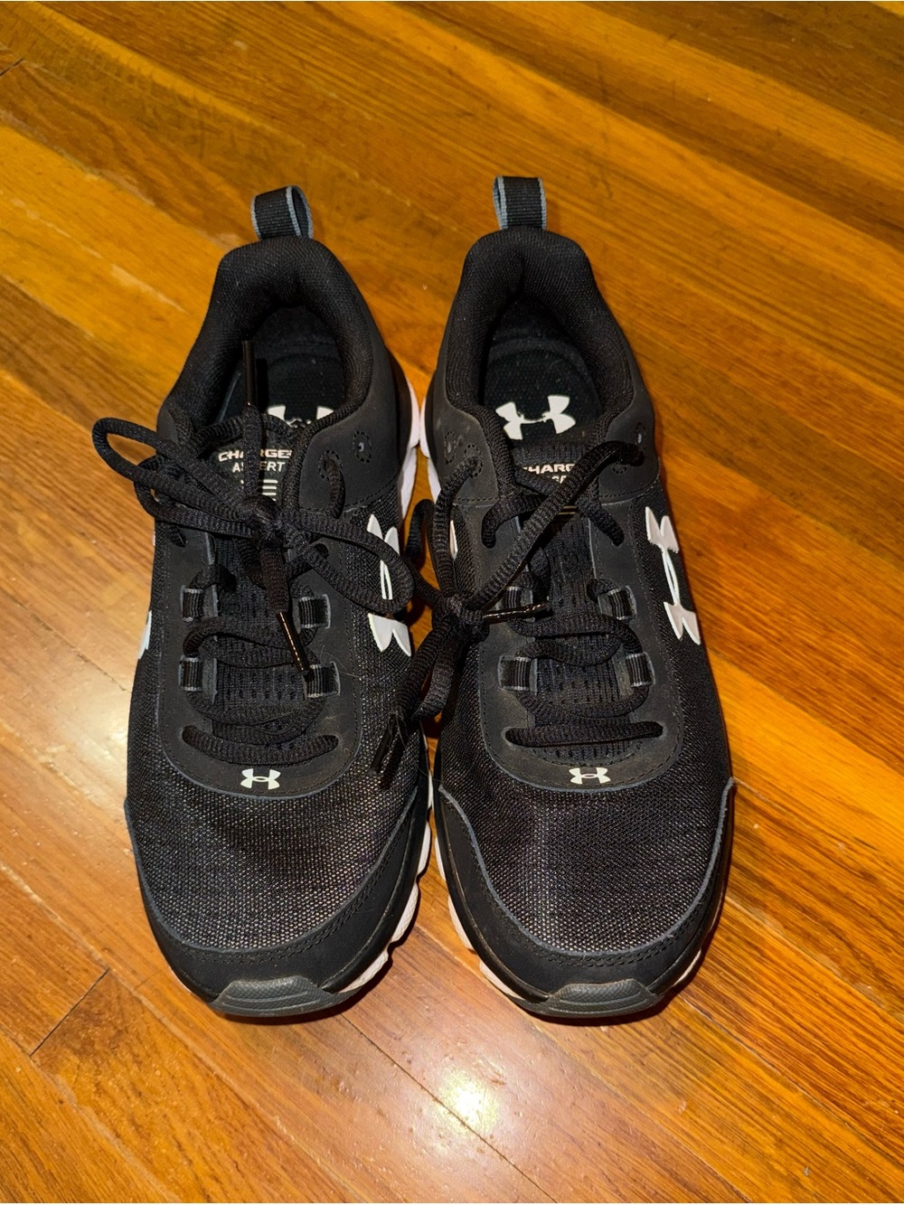Women’s Black and White Under Armour Assert Sneakers